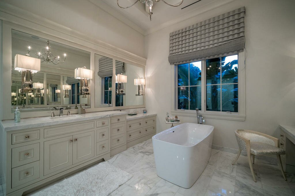 Elegant bathroom with freestanding tub and marble floors.