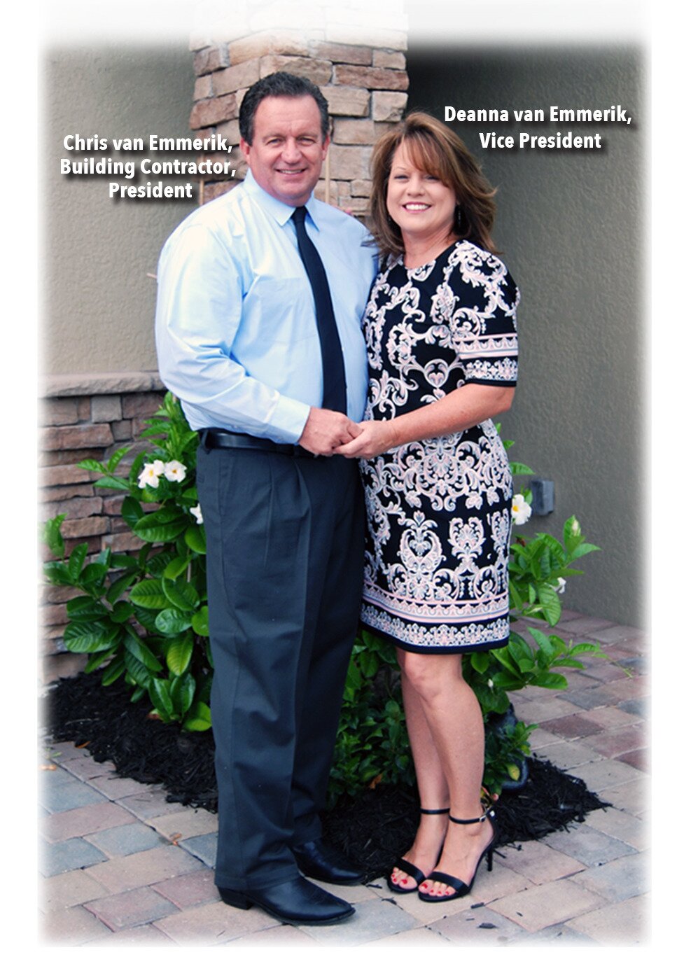 Couple posing outdoors, dressed formally and smiling.